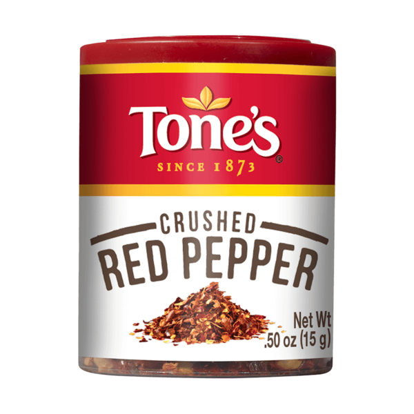 Enhance your culinary creations with Tone's Crushed Red Pepper flakes, featuring hot red pepper for a bold and pungent flavor in your meals.